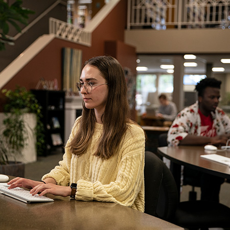 Students searching for resources in the library