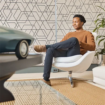 Farai Piloto sitting with a model card in front of him