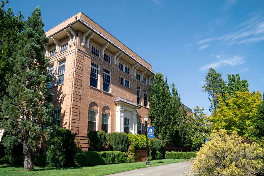 The greenery around the Wood-Mar building on campus on a sunny day