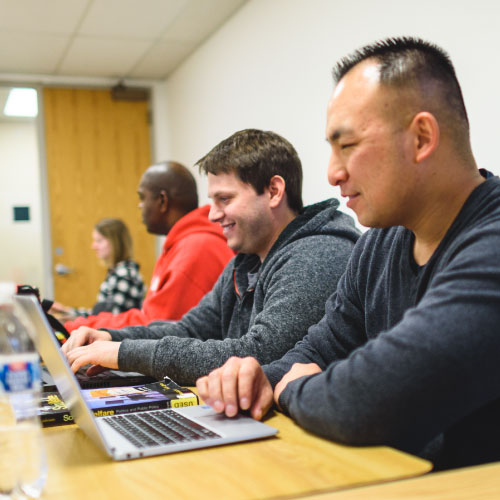 Adults degree completion students working in a classroom