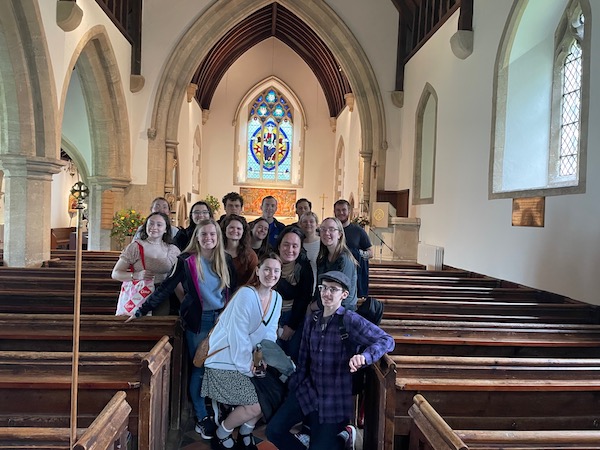 Students stand in the sanctuary of an old church