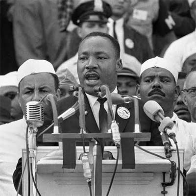 Martin Luther King Jr. speaking in front of a microphone