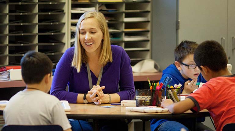 A student practices teaching in an elementary school classroom