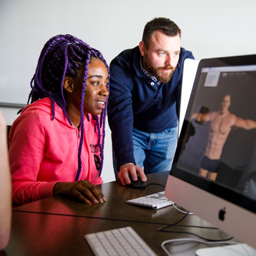 professor and student at a computer