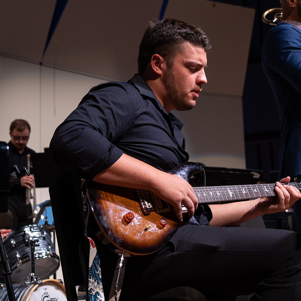 Student plays guitar