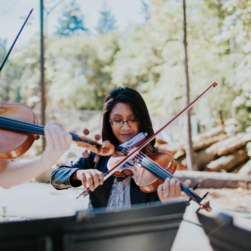 Student plays violin outside