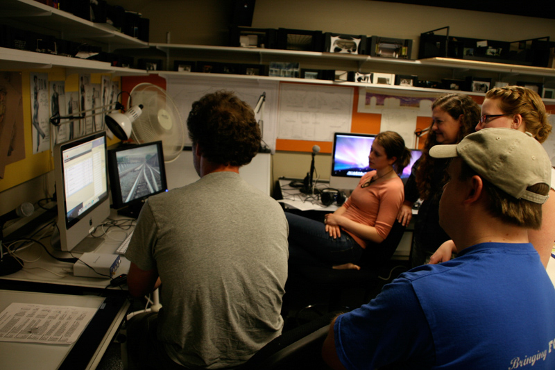 Students gather around a computer