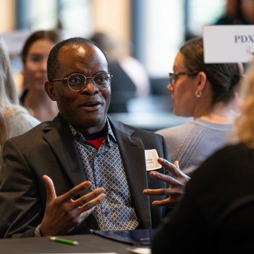 social work student speaking with a company at a career fair