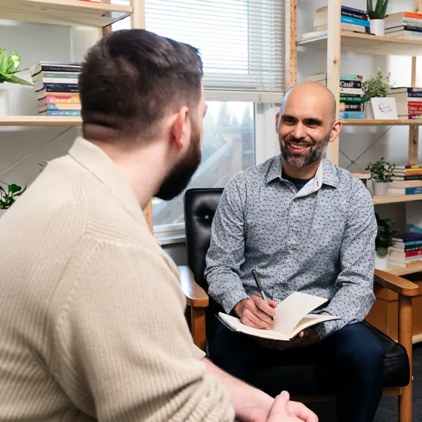 A George Fox counseling graduate speaks with a client