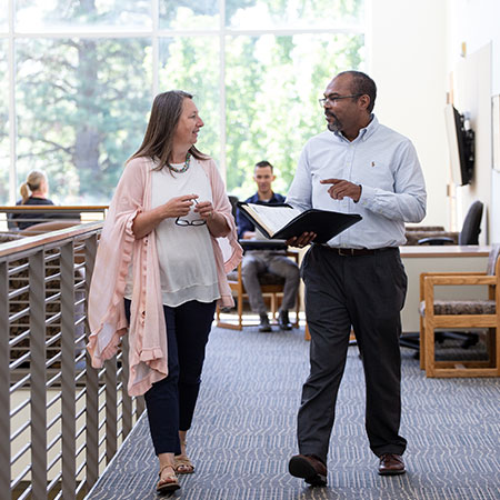 Two people talking in a healthcare facility