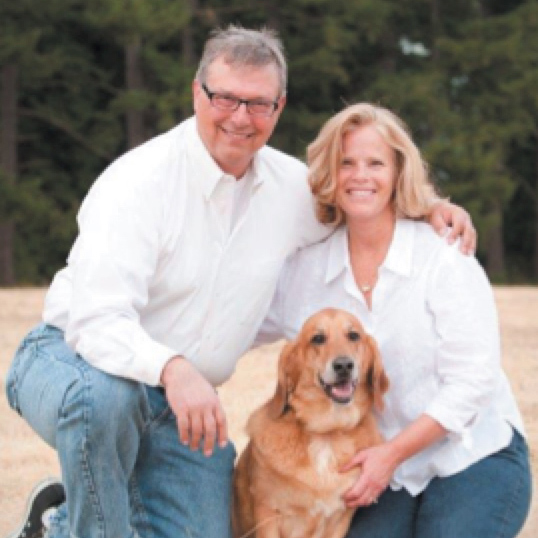 Roger Button and his wife pose with their dog