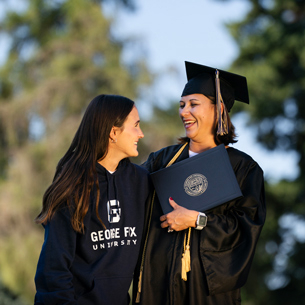 Alumni graduate and daughter