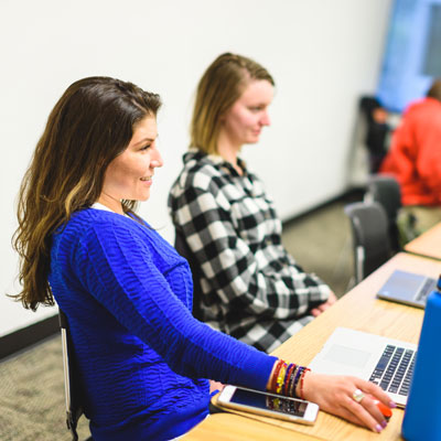 Woman sits in class