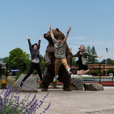 3 alumni jump for joy