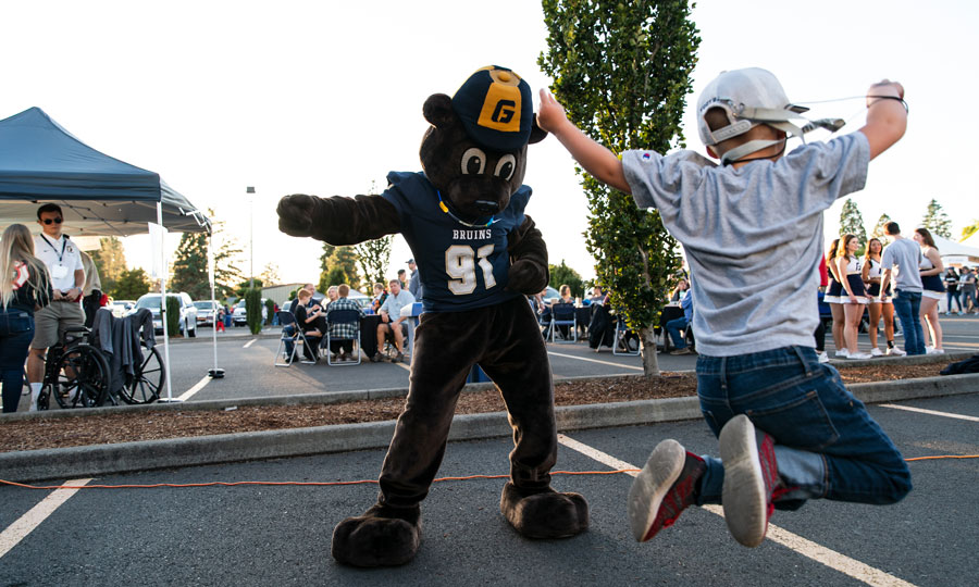 A jumping child and our mascot, Pennington Bear