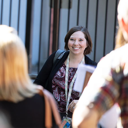 A smiling student walking on campus