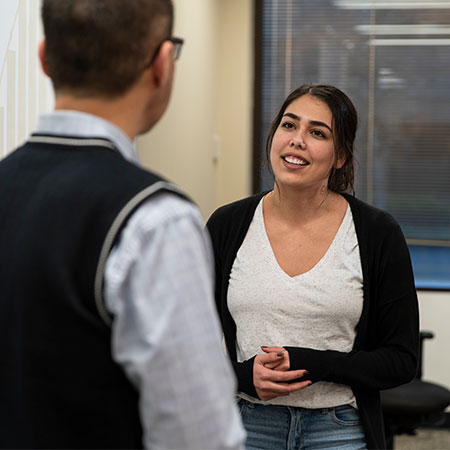 A student in MSW program talking with a professor