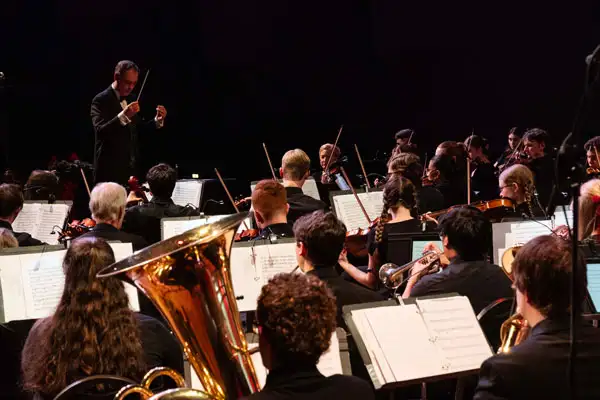 Students play instruments on stage
