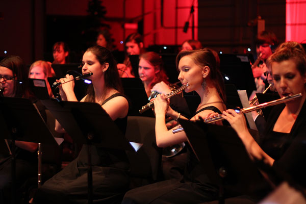 Student play wind isntruments on stage