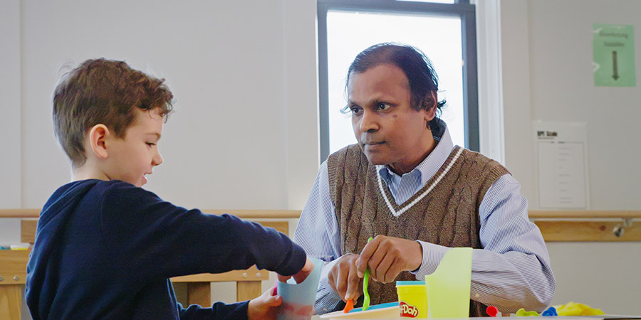 Stanley Paul guiding a child