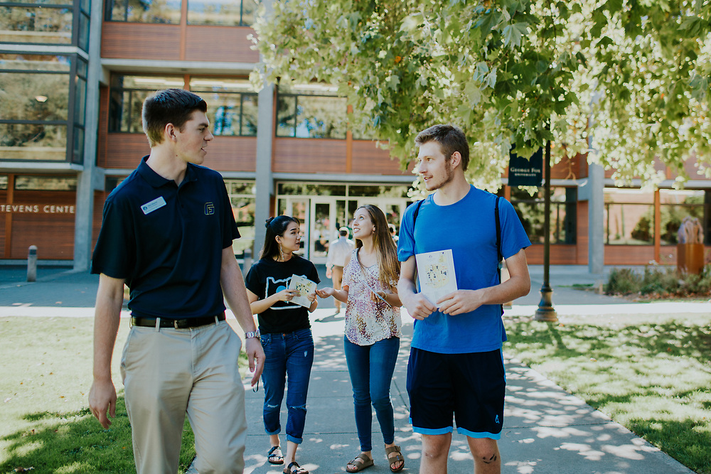 A campus tour guide speaks to a prospective student