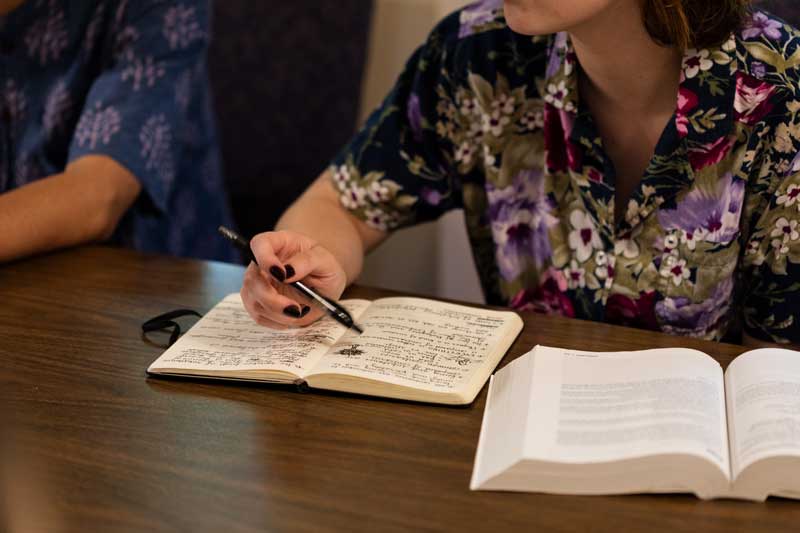 A student views her notes during a Socratic seminar