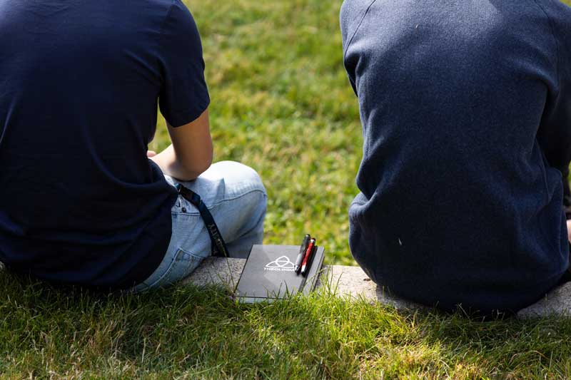 Two students sit side-by-side