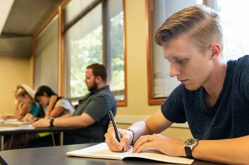 A student takes notes in class
