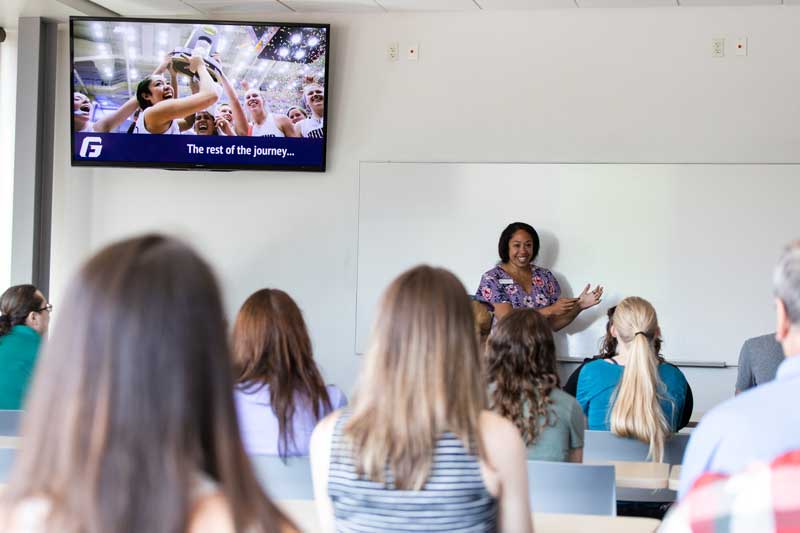The post's author speaks to a classroom of students