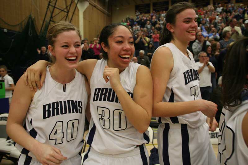 Girls on the basketball team celebrate after winning the national championship