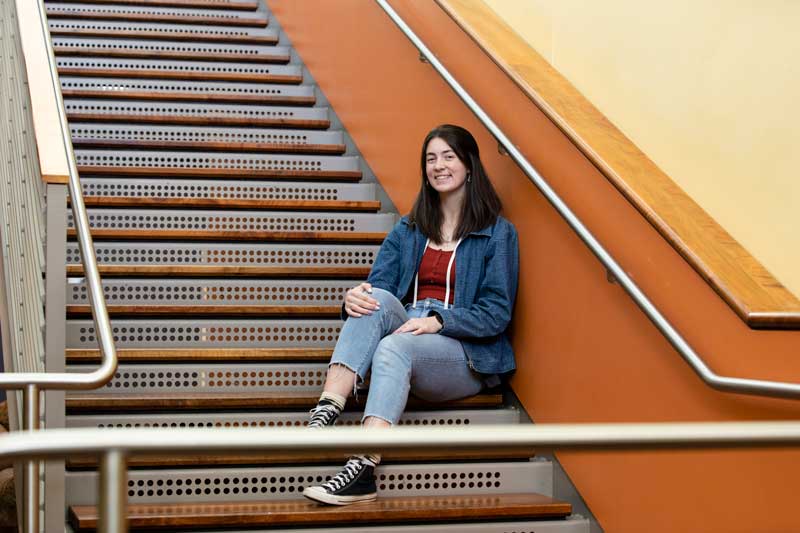 Daria sits on a staircase