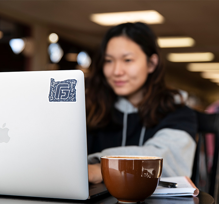 A student working at her laptop