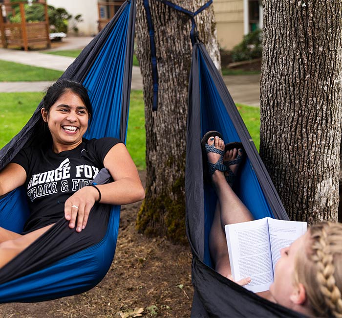 Two students relaxing in hammocks