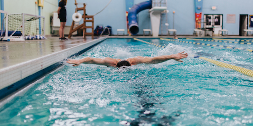 A student swimming in a pool