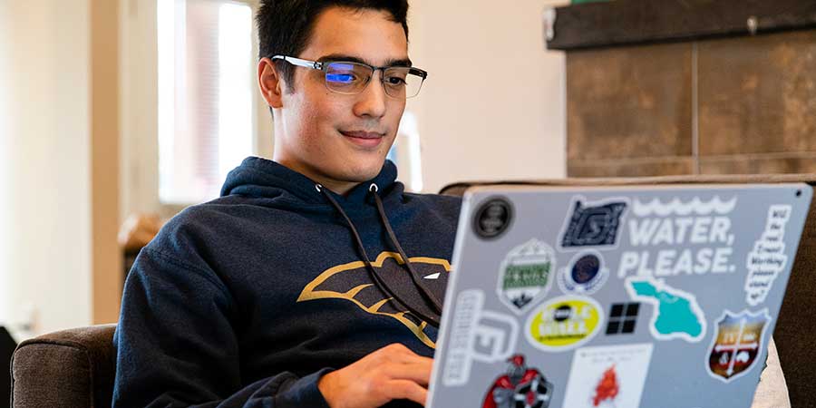 Student studying on a laptop