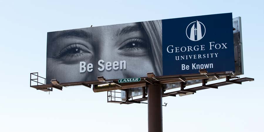 Billboard with the phrase 'be seen' on it