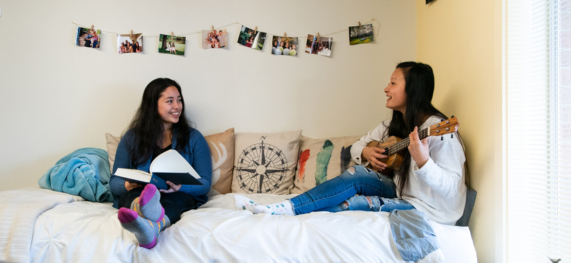 Two roommates laughing together.