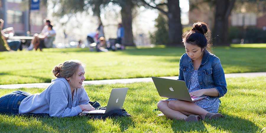 girls studying on the quad