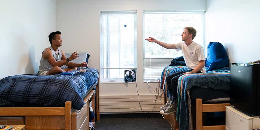 two students hanging out in their dorm