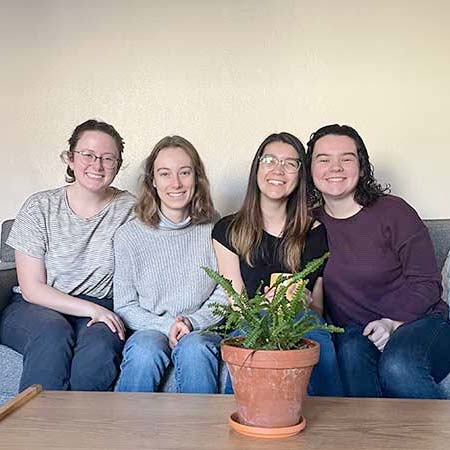 four seniors on their living room couch