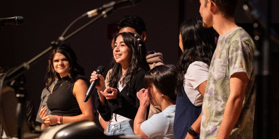 students leading worship on stage