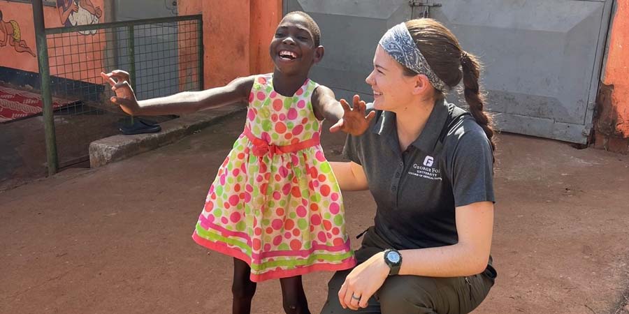Desiray Anderson with a child in Uganda