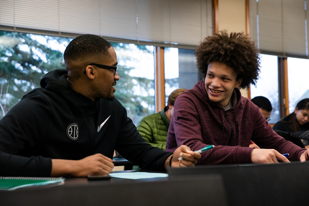 two students taking notes