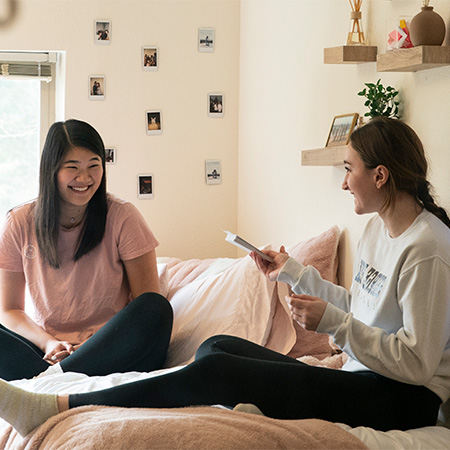 Two roommates looking at each other and smiling