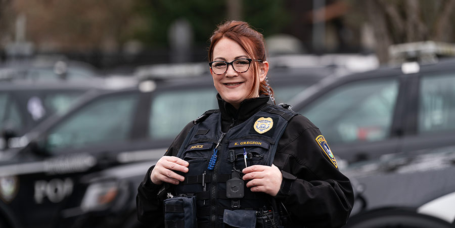 Kary Gregson standing next to police cars