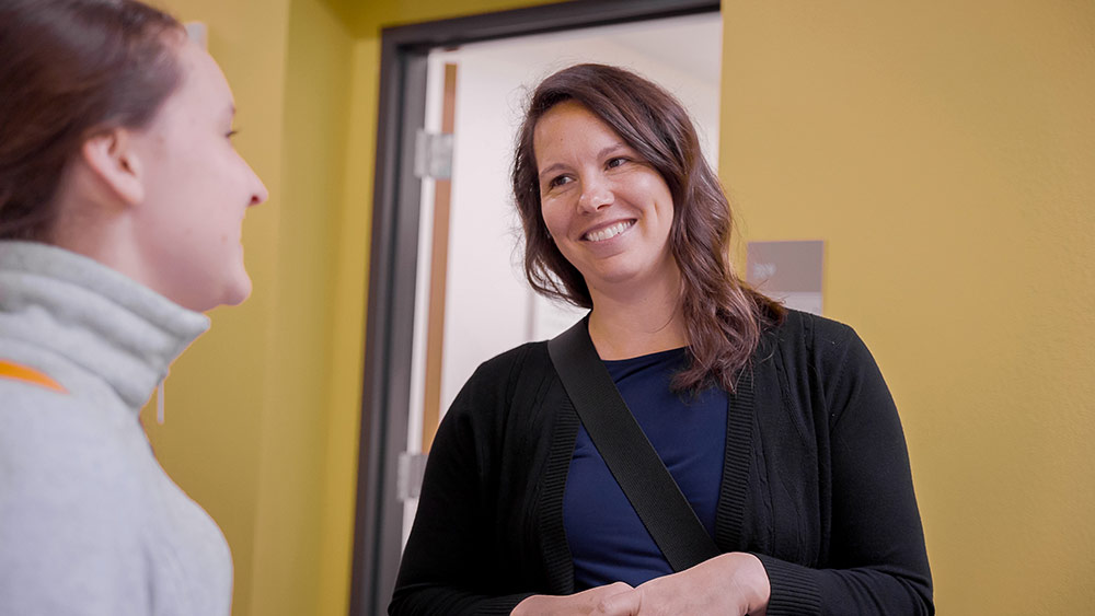 Kate Turner speaking to a student