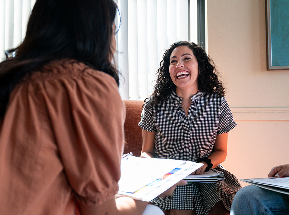 A life group leader talks and laughs with a student mentee