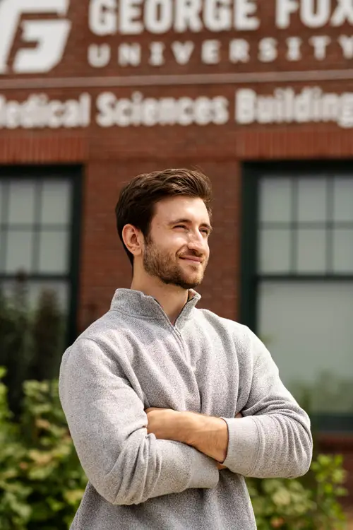 Stan poses for a portrait outside of the George Fox Medical Sciences Building