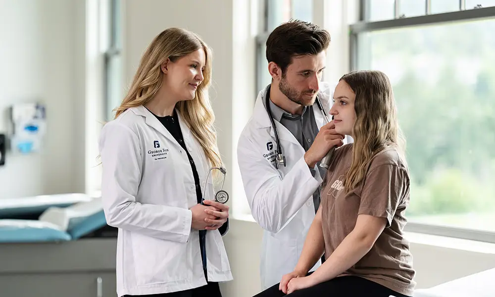 Stan works with a patient and another PA