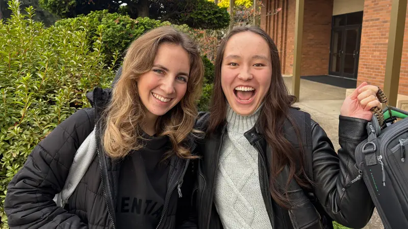 Two students smiling
